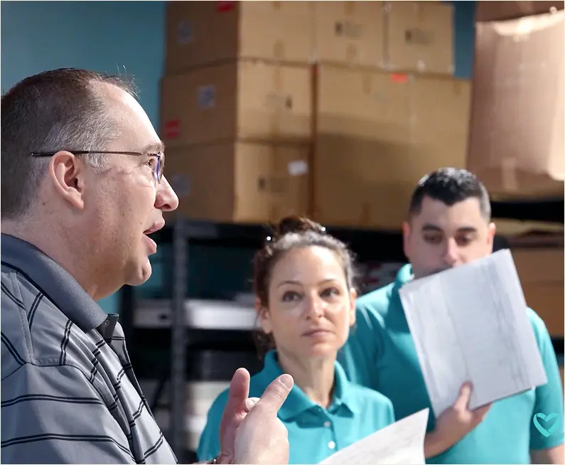 man speaking to group of people