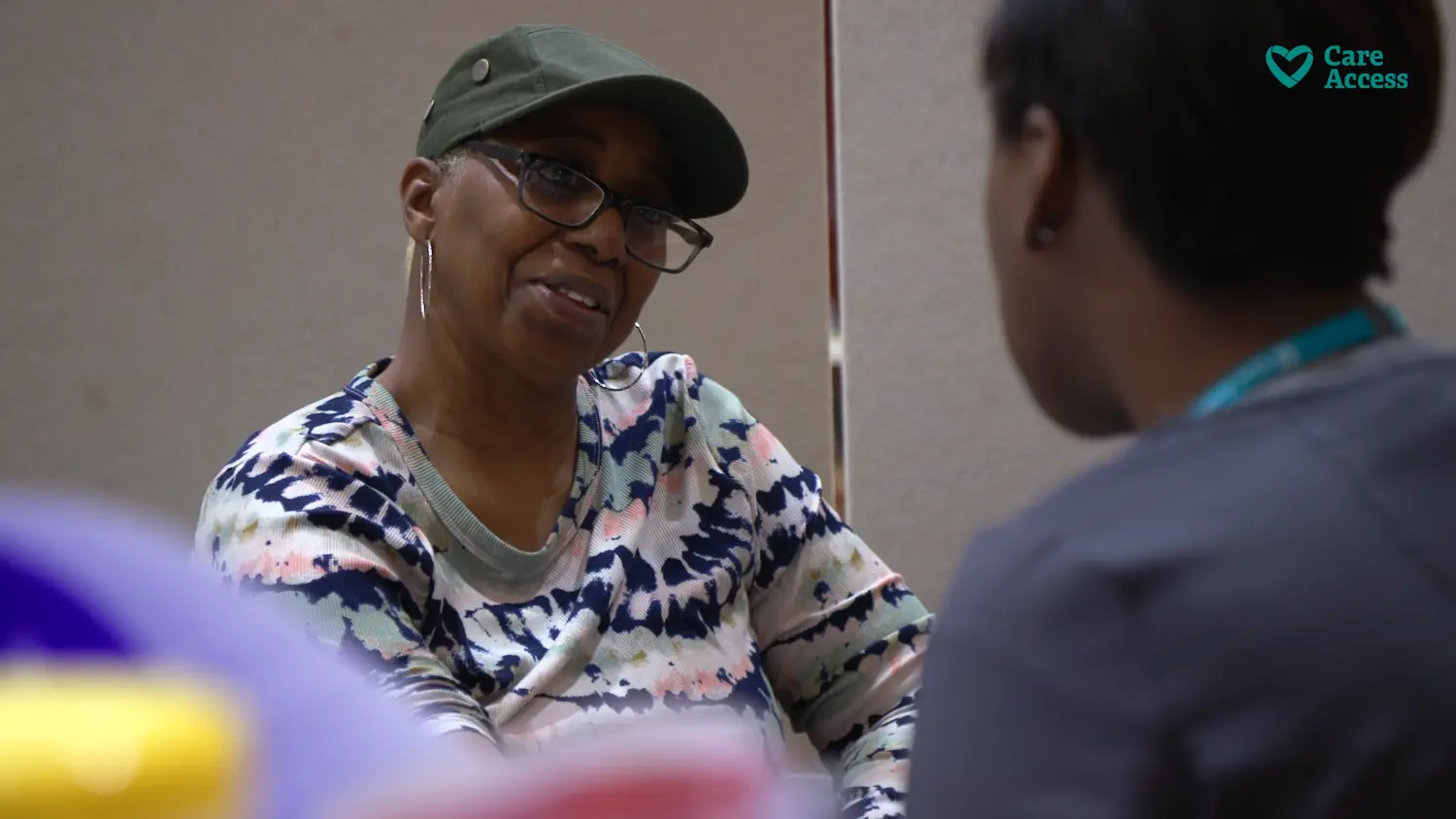 smiling woman being assisted by healthcare professional