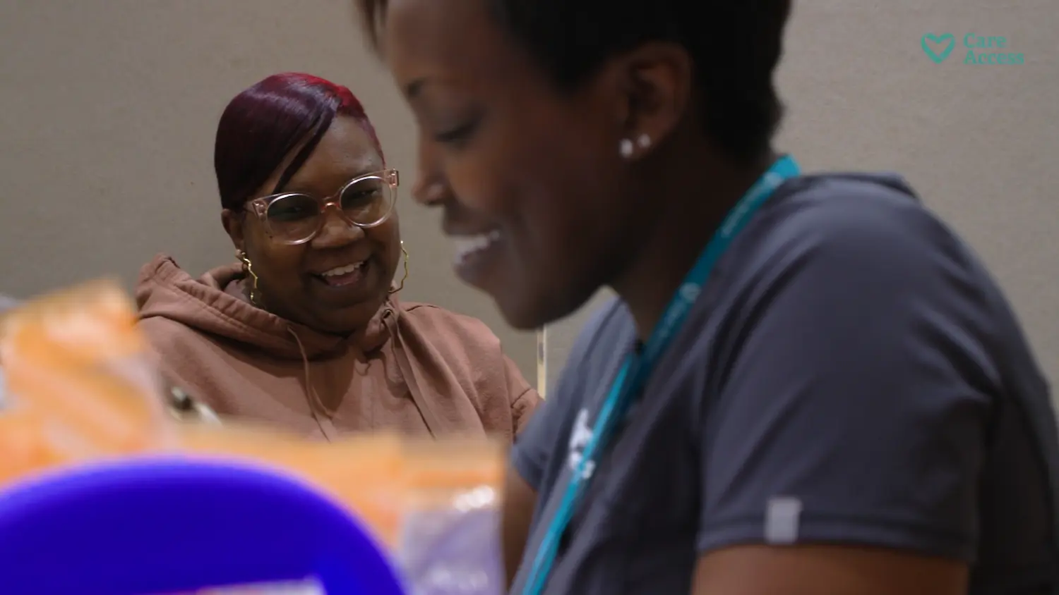 smiling woman being assisted by healthcare professional