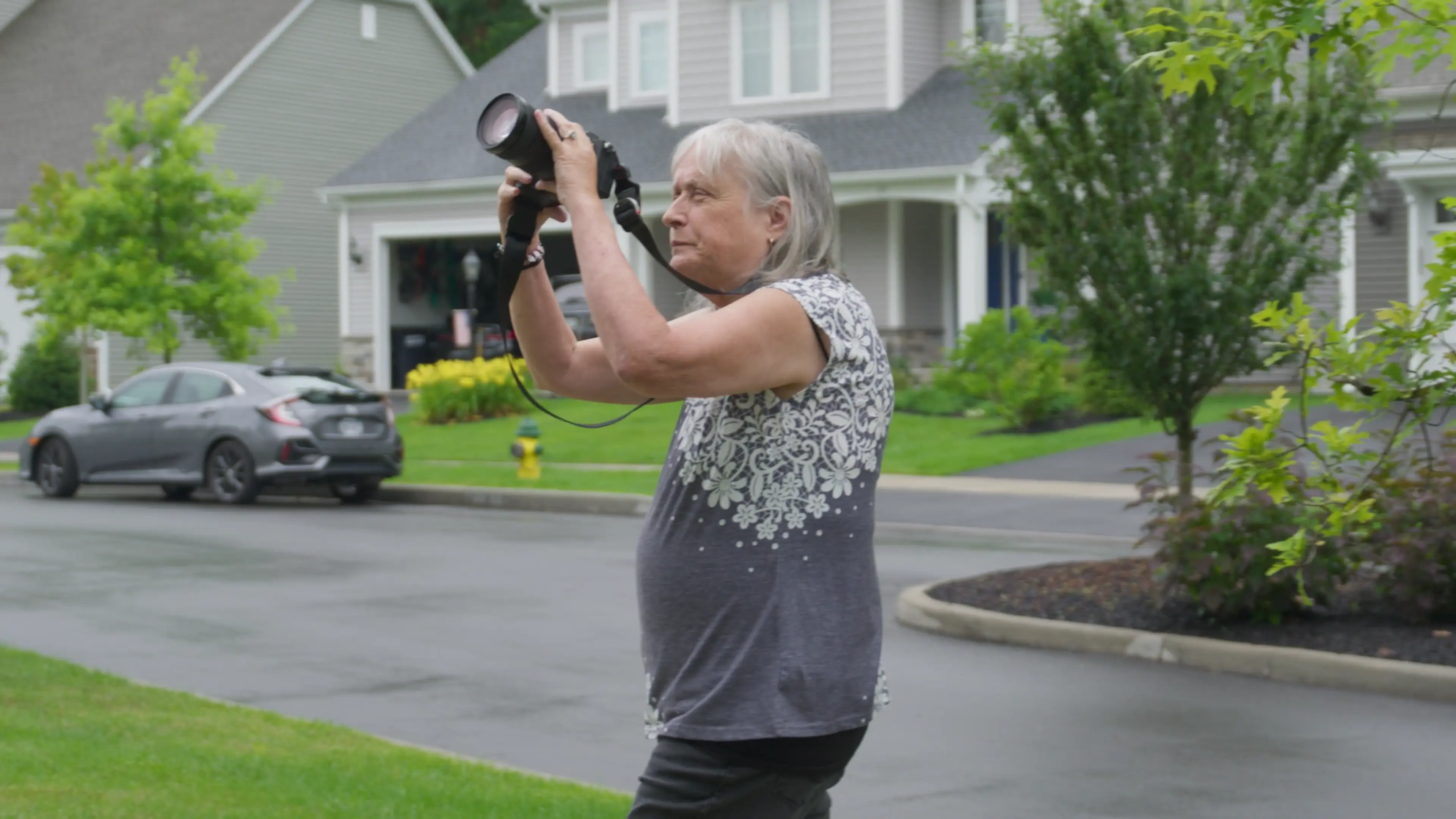 Fran taking a photo of a house