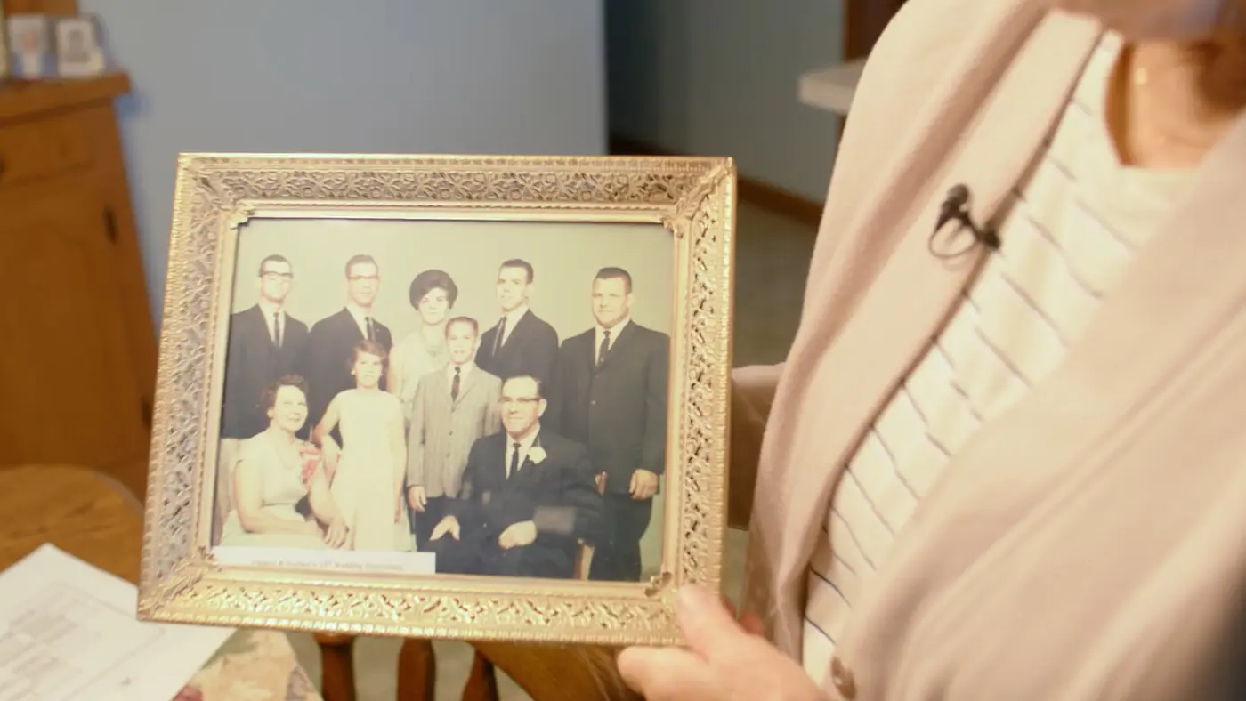 Joyce showing her family picture