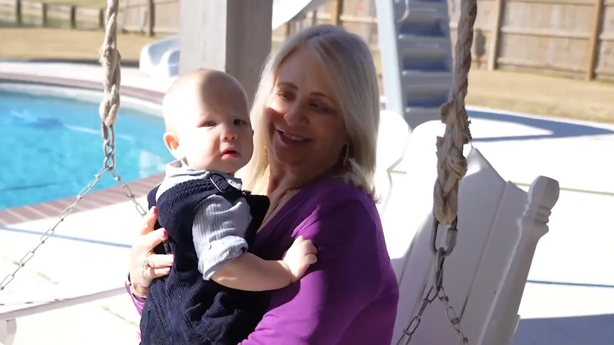 Susan holding her grandchild